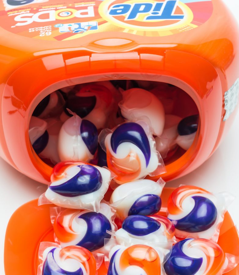 Miami, Fl, USA - October 16, 2013: A close up shot of an open fish bowl shaped plastic vessel containing 62 Tide Brand Pods capsules. Each dissolvable capsule consists of pre- measured amounts of detergent,stain remover and brightener for one load of laundry.